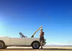 Photograph Caucasian woman stranded with broken down convertible on remote road by Gable Denims on 5